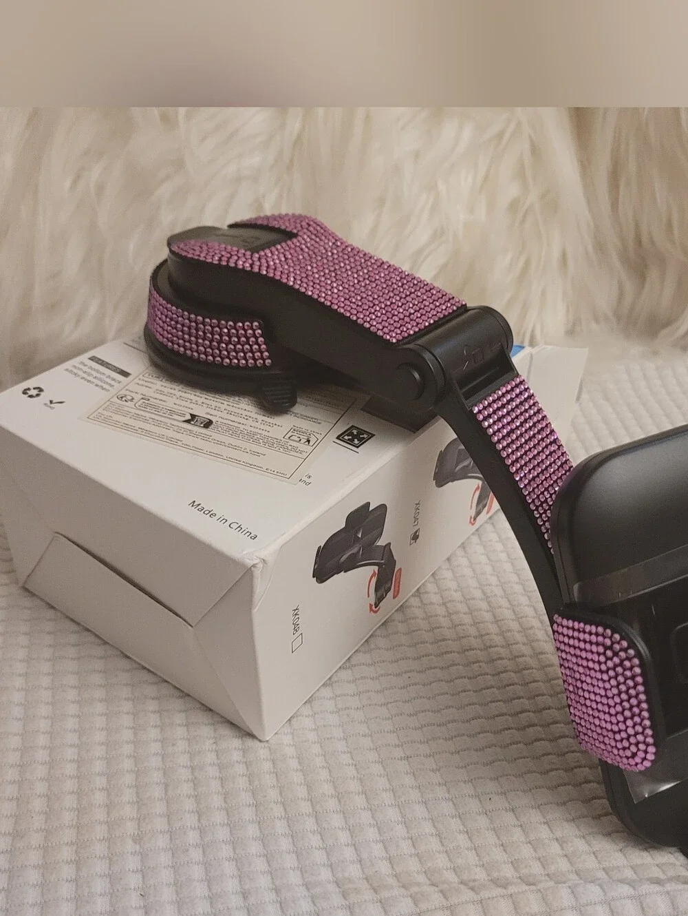 Pink universal car phone holder designed for attachment to a dashboard